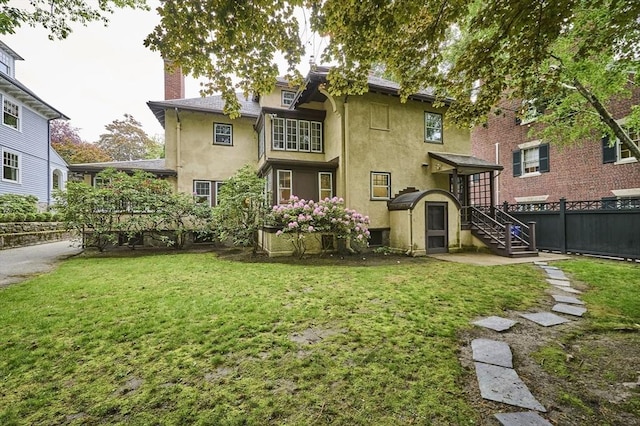 92 Dean Rd, Brookline, MA 02445 - back of house with stucco siding, stairway, and a chimney