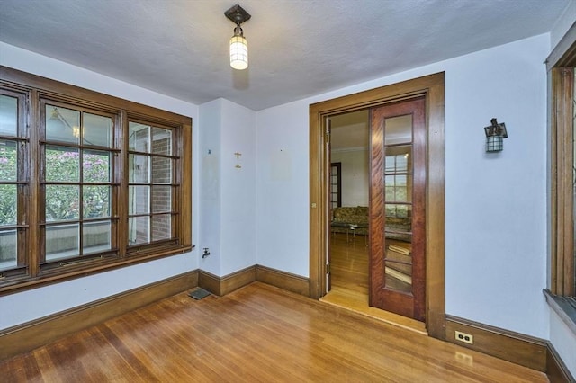92 Dean Rd, Brookline, MA 02445 - spare room featuring baseboards, wood finished floors, and plenty of natural light