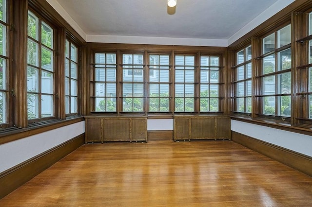 92 Dean Rd, Brookline, MA 02445 - unfurnished sunroom with wood finished floors, french doors, and plenty of natural light