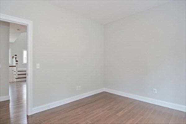 spare room with dark wood-type flooring