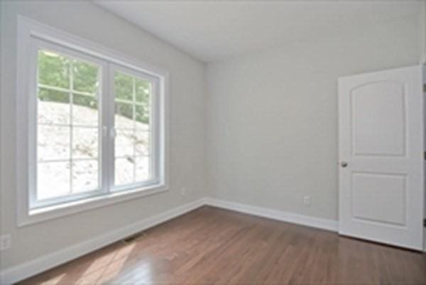 spare room featuring dark hardwood / wood-style floors