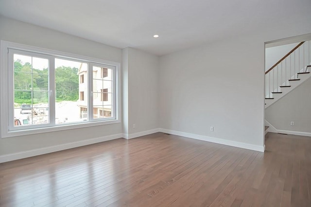 spare room featuring wood-type flooring