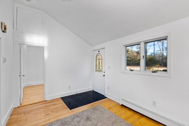 entrance foyer featuring hardwood / wood-style floors, lofted ceiling, and a baseboard heating unit