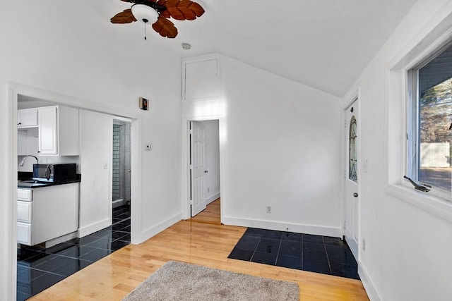 interior space featuring white cabinetry, dark hardwood / wood-style flooring, ceiling fan, and plenty of natural light