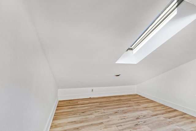 bonus room featuring light wood-type flooring and lofted ceiling