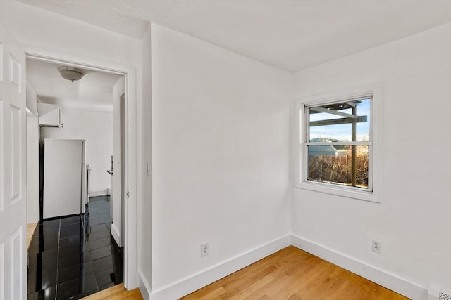 unfurnished room with hardwood / wood-style floors