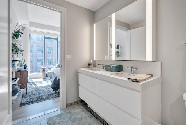 bathroom featuring dual vanity and hardwood / wood-style flooring