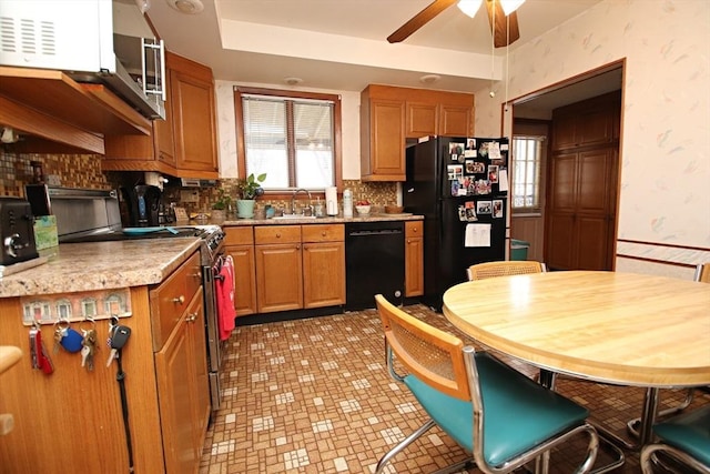 kitchen featuring sink, ceiling fan, black appliances, and decorative backsplash