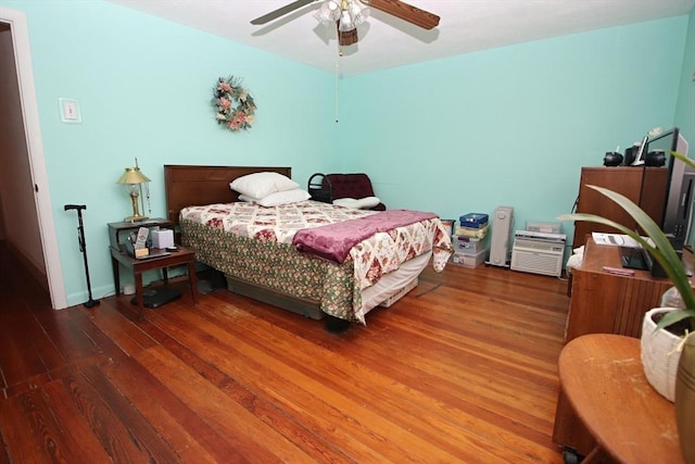 bedroom featuring dark hardwood / wood-style flooring and ceiling fan