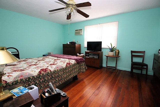 bedroom featuring ceiling fan, dark hardwood / wood-style flooring, and a wall unit AC