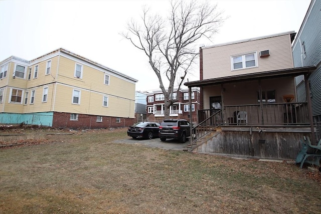 view of home's exterior featuring covered porch and a lawn