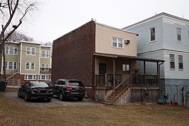 back of property featuring a porch and a yard