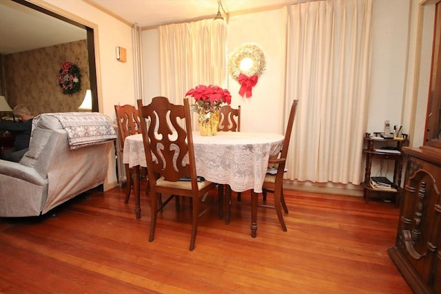 dining space featuring ornamental molding and hardwood / wood-style flooring