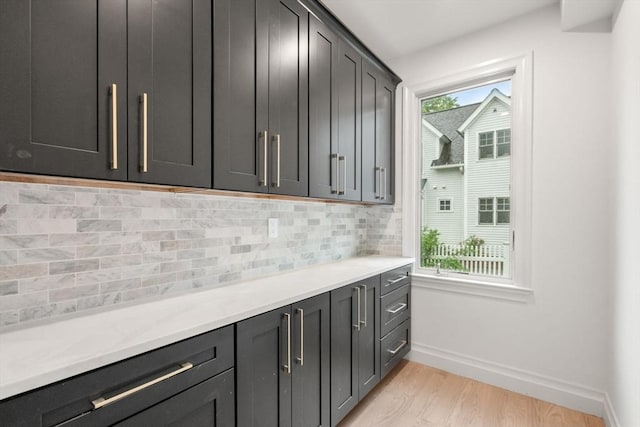 57 Mayflower Rd, Needham, MA 02492 - kitchen with light wood finished floors, baseboards, decorative backsplash, and light countertops