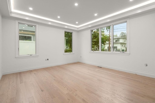 57 Mayflower Rd, Needham, MA 02492 - empty room featuring a tray ceiling, light wood-style flooring, recessed lighting, and baseboards