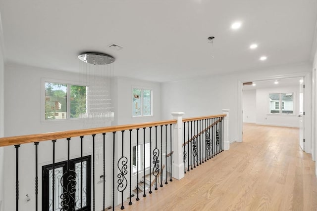 57 Mayflower Rd, Needham, MA 02492 - hallway featuring wood finished floors, plenty of natural light, recessed lighting, and an upstairs landing
