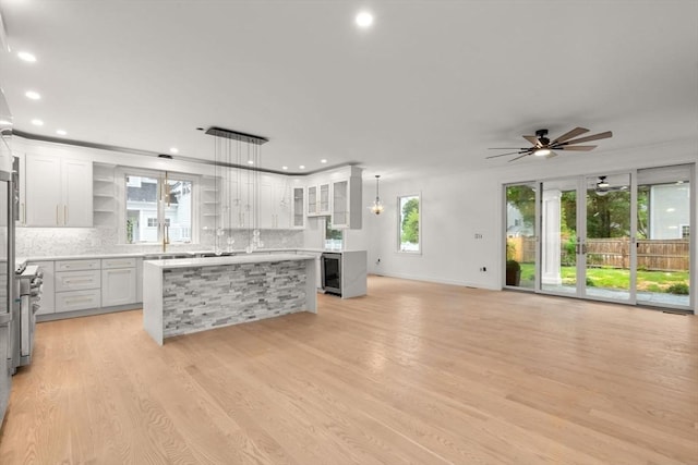 57 Mayflower Rd, Needham, MA 02492 - kitchen with open shelves, decorative backsplash, plenty of natural light, light countertops, and recessed lighting