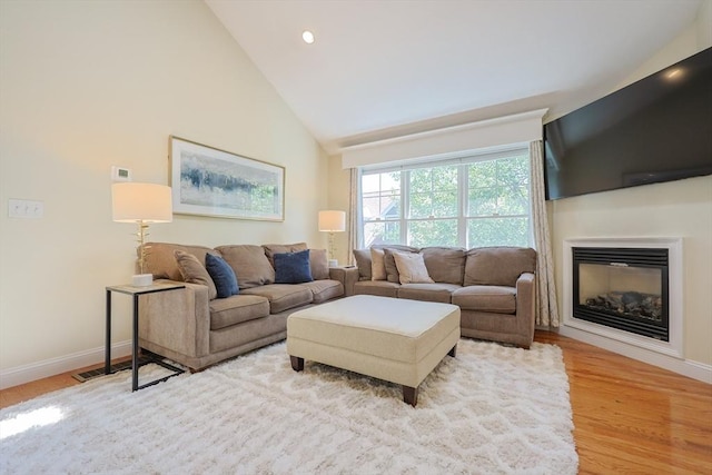 1 Washington Ct Unit 1, Uxbridge, MA 01569 - living room featuring light wood-type flooring, baseboards, a glass covered fireplace, high vaulted ceiling, and recessed lighting