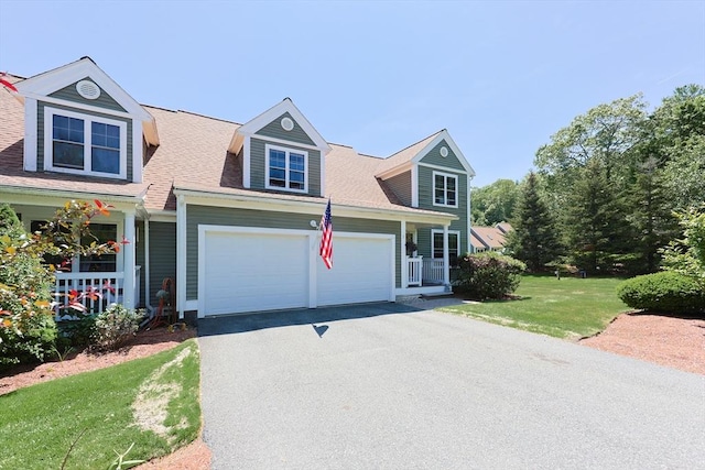 1 Washington Ct Unit 1, Uxbridge, MA 01569 - view of front of home featuring asphalt driveway, a garage, a front yard, and a porch