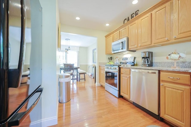 1 Washington Ct Unit 1, Uxbridge, MA 01569 - kitchen with stainless steel appliances, light brown cabinetry, light wood-type flooring, recessed lighting, and light stone counters