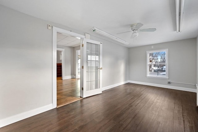 empty room featuring dark hardwood / wood-style flooring and ceiling fan