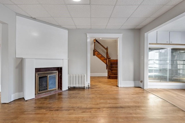 unfurnished living room featuring light hardwood / wood-style floors and radiator