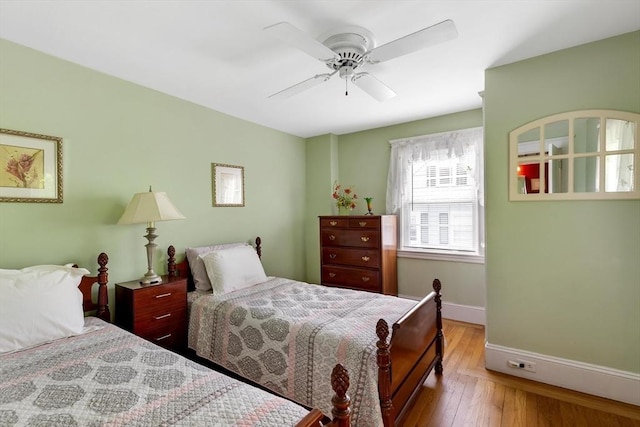 bedroom with baseboards, hardwood / wood-style flooring, and a ceiling fan