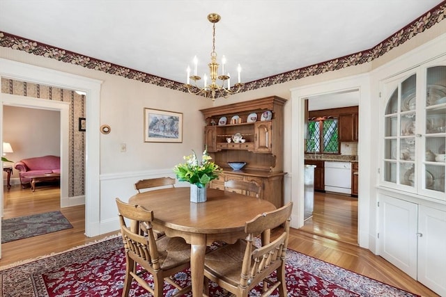 dining space featuring a chandelier and light wood-style floors