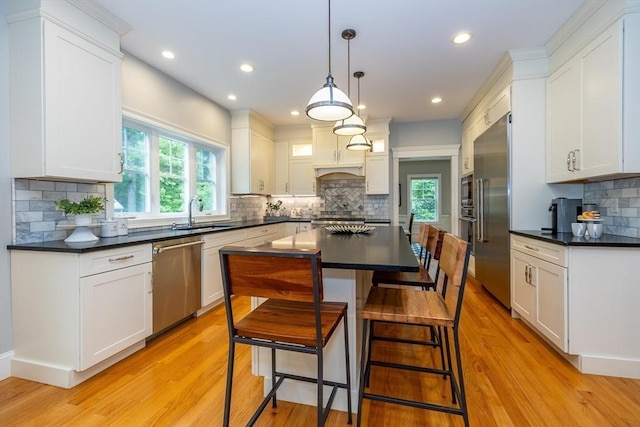 11 Liberty Ave, Burlington, MA 01803 - kitchen featuring stainless steel appliances, dark countertops, decorative backsplash, and recessed lighting