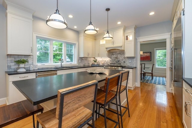 11 Liberty Ave, Burlington, MA 01803 - kitchen featuring a sink, dark countertops, white cabinets, tasteful backsplash, and recessed lighting