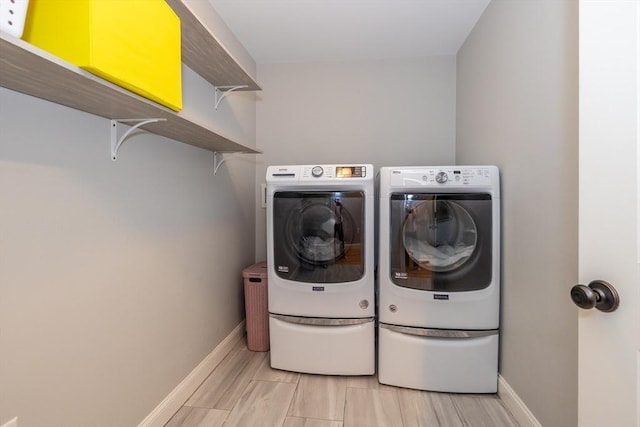 11 Liberty Ave, Burlington, MA 01803 - washroom featuring washing machine and clothes dryer, baseboards, and light wood-style floors