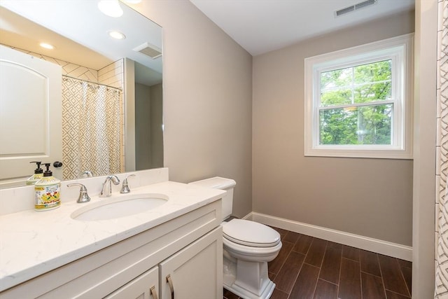 11 Liberty Ave, Burlington, MA 01803 - bathroom with baseboards, vanity, toilet, wood tiled floors, and recessed lighting