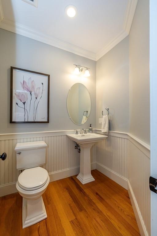 11 Liberty Ave, Burlington, MA 01803 - half bath with wood finished floors, wainscoting, toilet, and ornamental molding