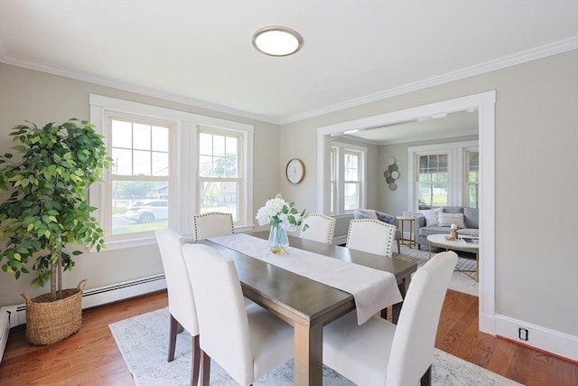 21 Trefton Dr, Braintree, MA 02184 - dining area featuring healthy amount of natural light, crown molding, a baseboard heating unit, and wood finished floors