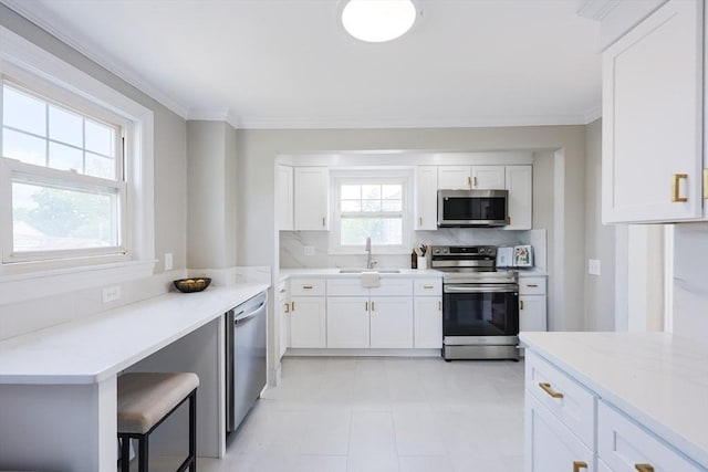 21 Trefton Dr, Braintree, MA 02184 - kitchen with appliances with stainless steel finishes, a sink, white cabinets, crown molding, and tasteful backsplash