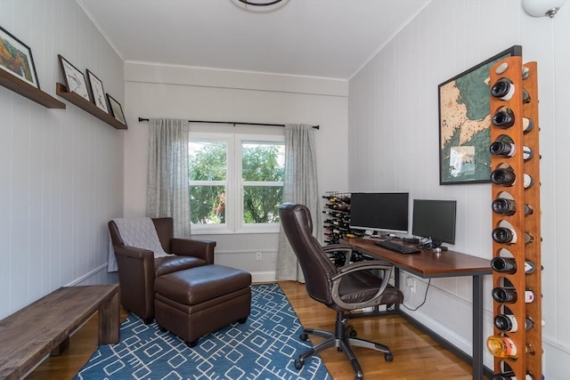 office featuring crown molding, wood walls, and wood finished floors