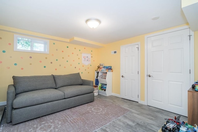 living room featuring baseboards and wood finished floors