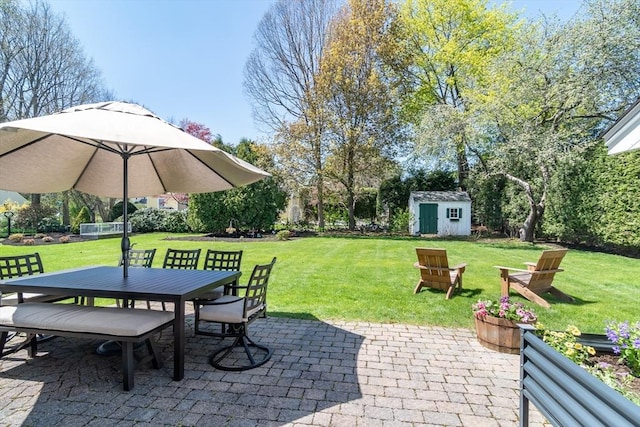 view of patio / terrace featuring a storage shed, an outdoor structure, and outdoor dining area