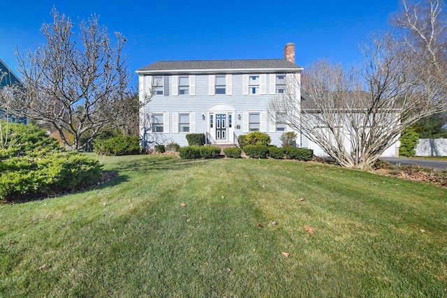 colonial inspired home with a front yard