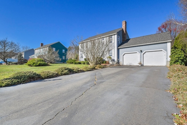 exterior space featuring a garage and a front lawn