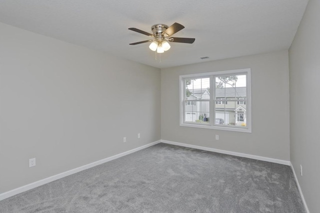 carpeted empty room featuring ceiling fan