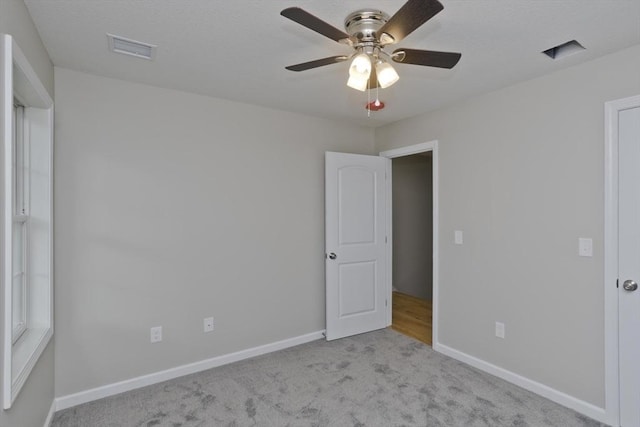 unfurnished bedroom featuring ceiling fan and light colored carpet