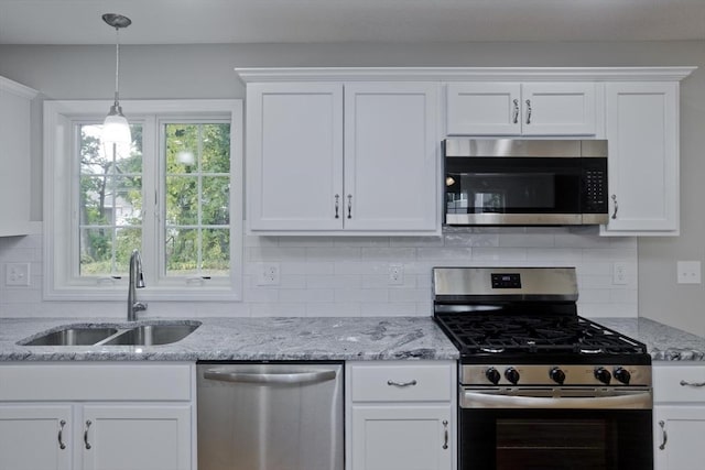 kitchen featuring white cabinets, appliances with stainless steel finishes, and sink