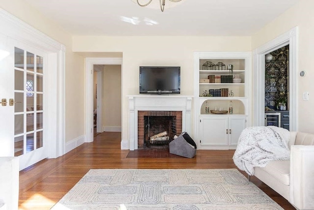 living room with a fireplace and hardwood / wood-style flooring