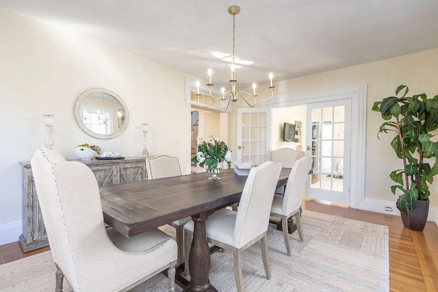 dining room featuring light hardwood / wood-style floors and a notable chandelier