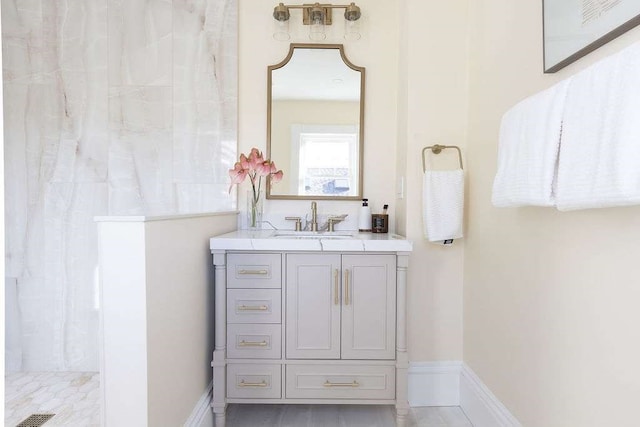 bathroom featuring a shower and vanity