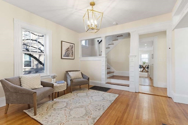 living area with a chandelier and hardwood / wood-style flooring