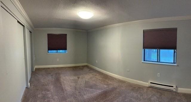 3 Village Rock Ln Unit 1, Natick, MA 01760 - unfurnished bedroom with a baseboard heating unit, crown molding, carpet flooring, baseboards, and a textured ceiling