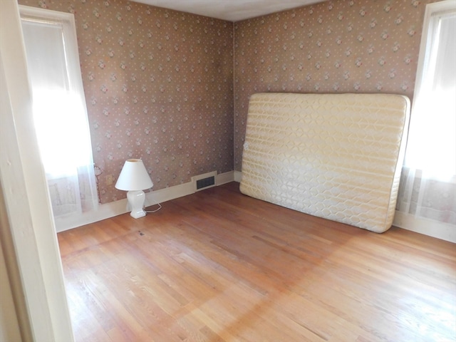 spare room with hardwood / wood-style flooring