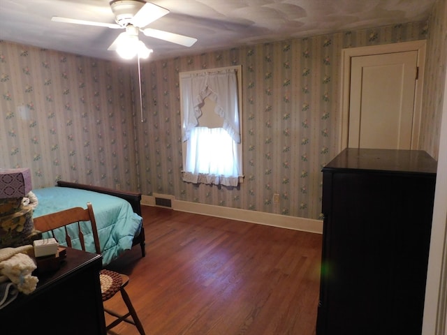 bedroom with hardwood / wood-style floors and ceiling fan